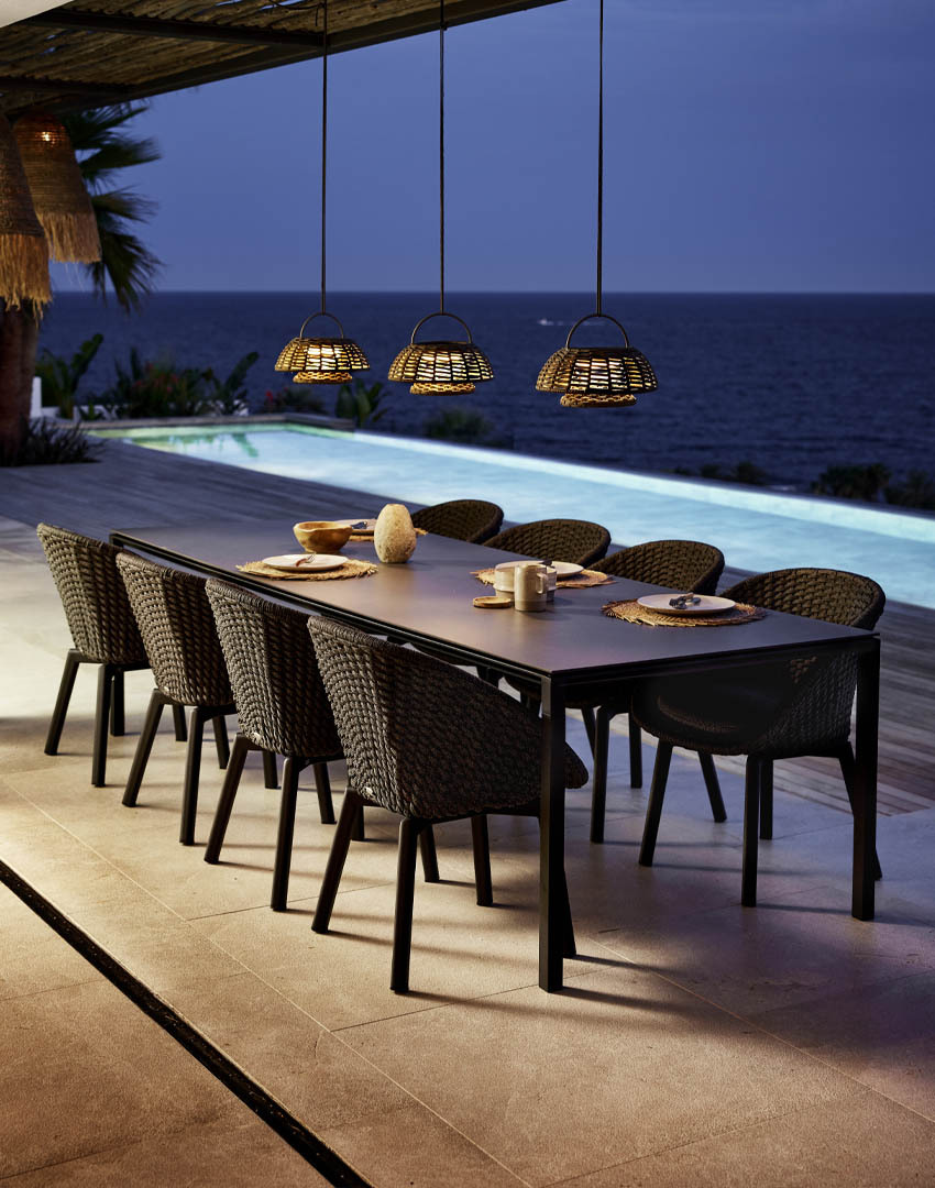 Cane-line Pure dining table with Peacock dining chairs and illusion lamps